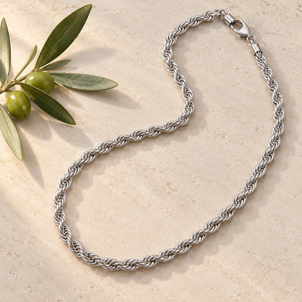 Silver-tone 5 mm rope chain necklace on a pale limestone background, with an olive sprig for scale — true size: the rope chain is 5 mm thick