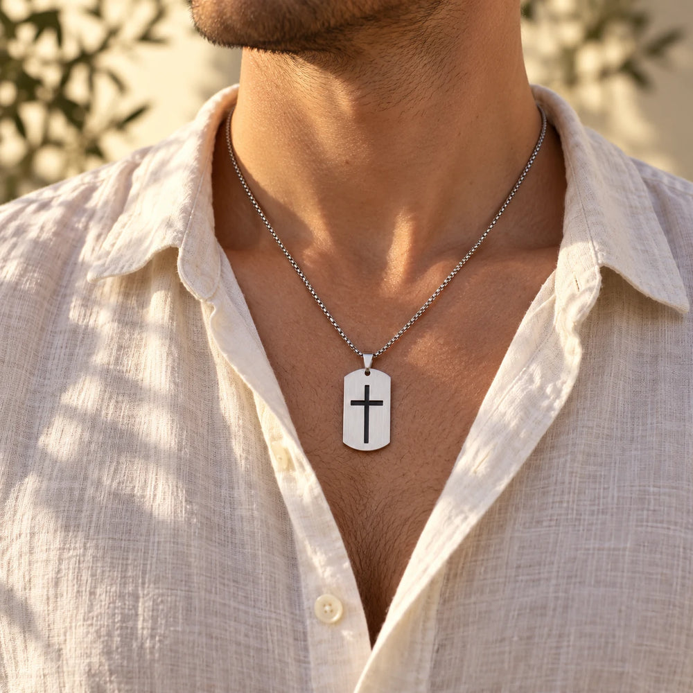 Silver-tone cross tag necklace worn by a man over a white t-shirt — true size: the tag is 40 mm tall and 24 mm wide (about 49 mm with the bail), on a box chain about 2.5–3 mm wide