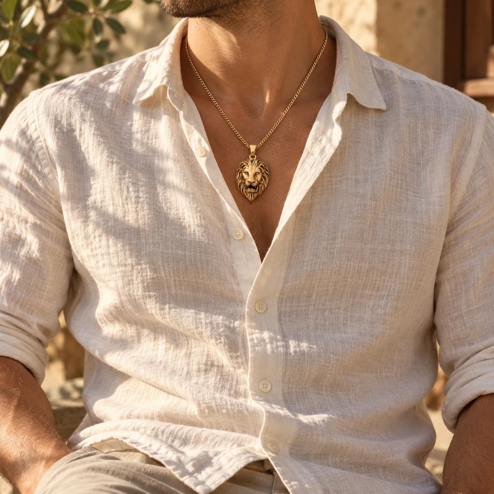 Silver-tone lion head pendant on a curb chain worn with an open white linen shirt — true size: the lion-head pendant is 44 mm tall and 27 mm wide (about 54 mm with the bail), thick and solid, on a curb chain about 3 mm wide