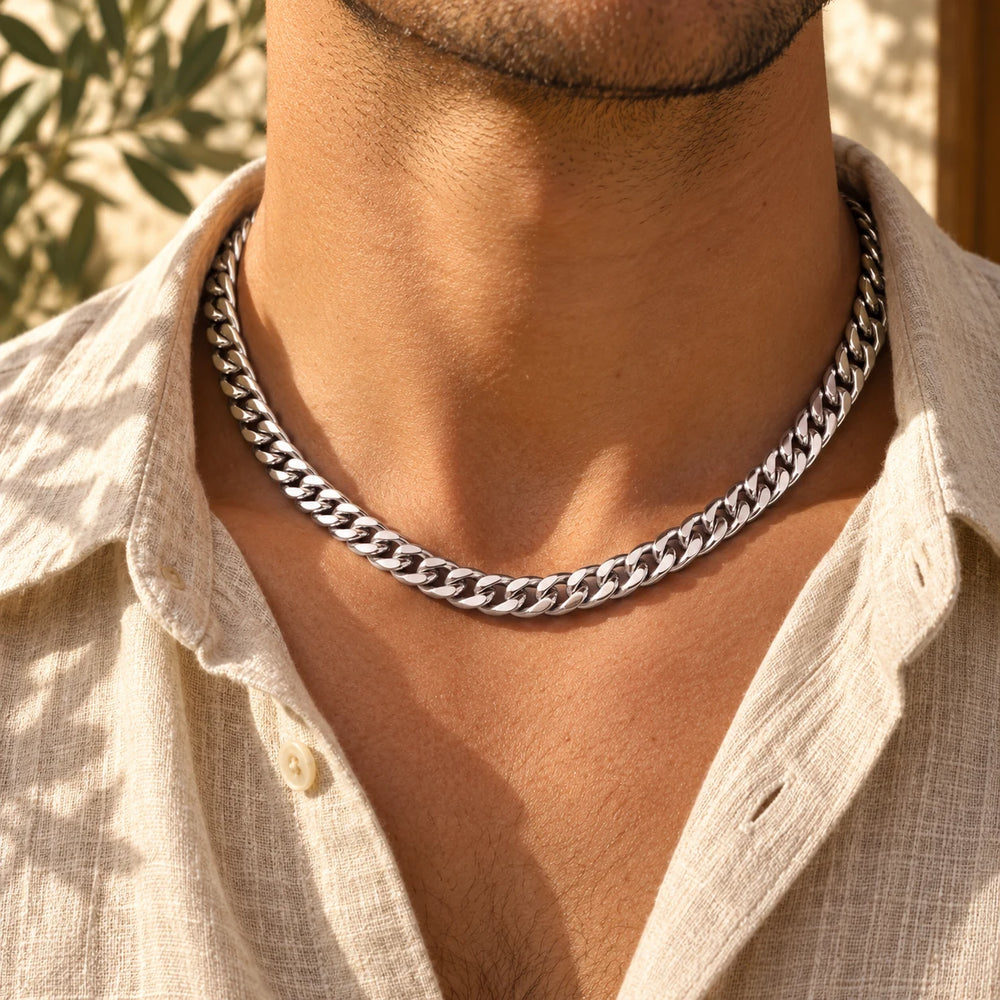 Silver-tone 8 mm cuban chain necklace worn at the collarbone with an open linen shirt — true size: the heavy cuban chain is 8 mm wide and about 1.8 mm thick