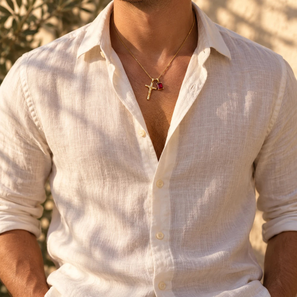 Silver-tone crucifix and red stone pendants worn over a white t-shirt — true size: the small cross is about 22 mm tall and hangs beside a rectangular stone about 10 × 8 mm, on a fine curb chain about 1.2 mm wide