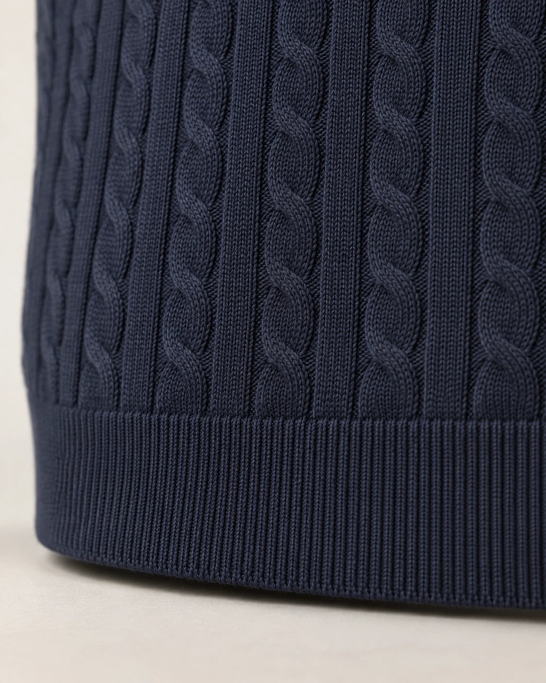 Small cables ending in the ribbed hem of the Kade navy sweater - Cable Knit and Ribbed Hem