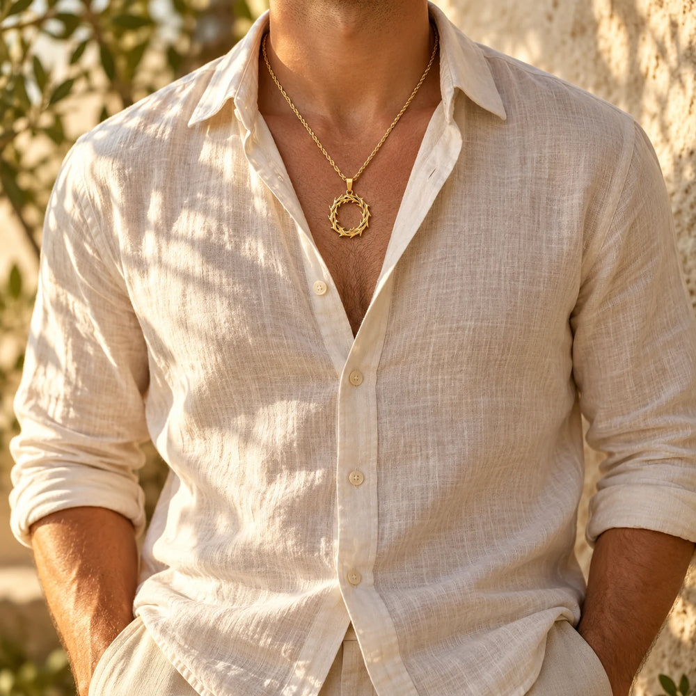 Gold-tone crown of thorns pendant on a rope chain worn with an open linen shirt — true size: the crown-of-thorns ring pendant is about 31 mm across and about 45 mm tall including its bail, on a rope chain about 3 mm thick