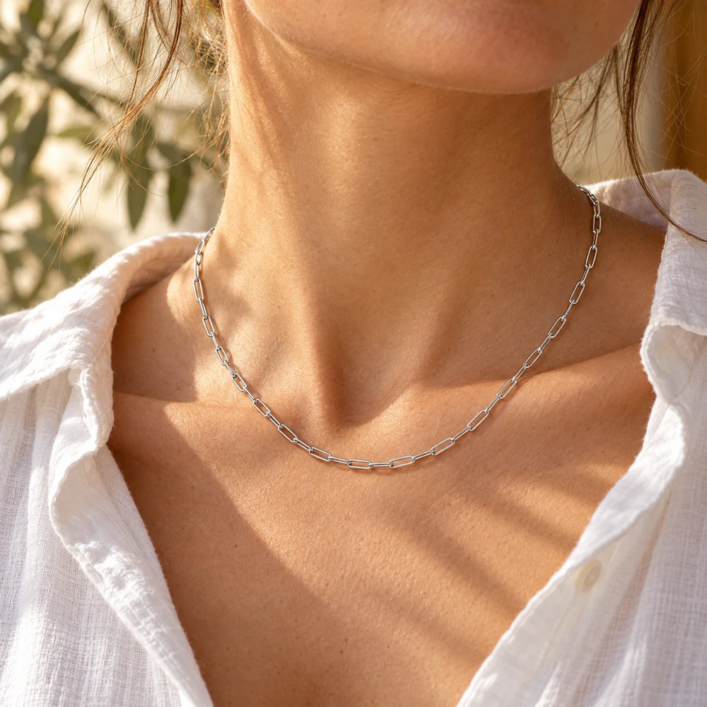 Silver-tone 3 mm paperclip chain necklace worn with an open white shirt — true size: each paperclip link is 3 mm wide and 9 mm long, 0.8 mm wire