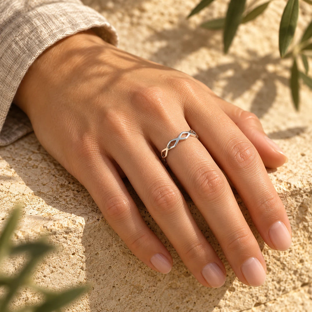Silver-tone woven ring worn on a woman's hand on limestone — true size: the band is only 4 mm wide, made of hair-thin wires, with an outer diameter of about 19 mm