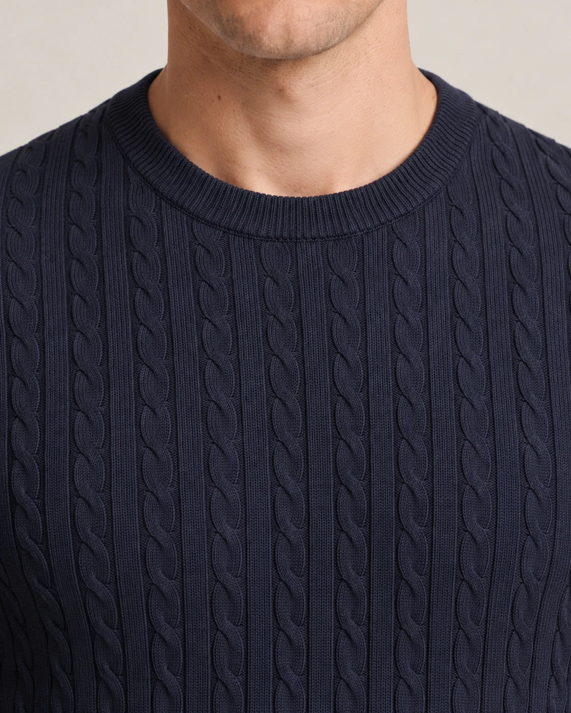 Close-up of the crew neck of the Kade navy cable-knit sweater, worn - Close-Fitting Crew Neck